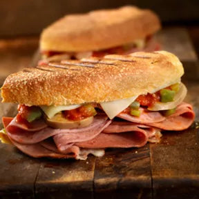 An image of a panini with meat and marinara sauce