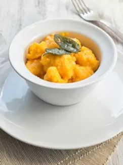 A bowl of gnocchi with butternut squash pasta sauce