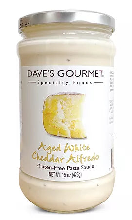 A jar of Dave's Gourmet Aged White Cheddar Alfredo Net Weight 15 oz